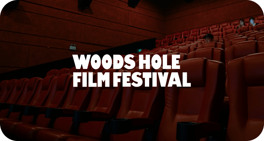 An empty theatre with a dark red filter and the Woods Hole Film Festival logo overlayed.