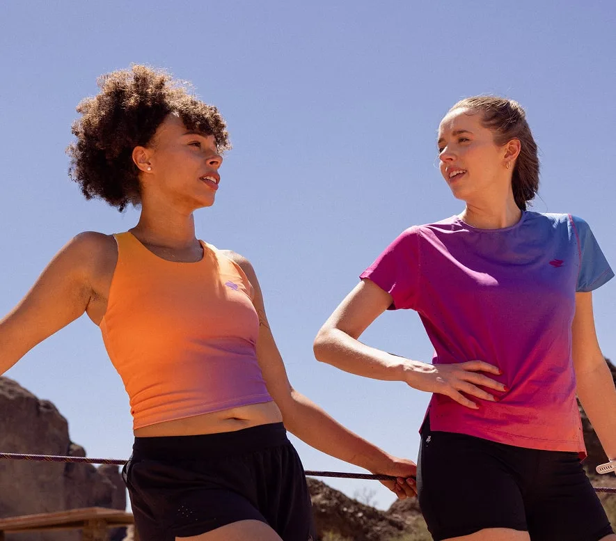 2 runners wear the Every Woman's Marathon Training kit as they rest after a short run.