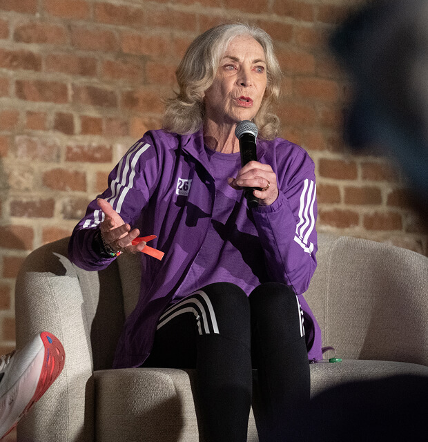 Kathrine Switzer speaks into a microphone during a panel discussion at Every Woman's Marathon.
