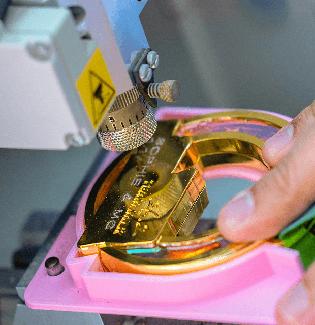 A medal being engraved.