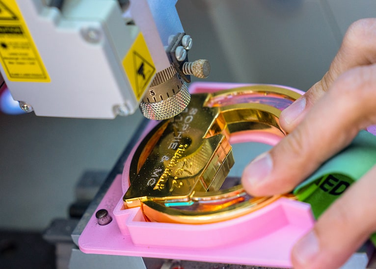 A medal being engraved.