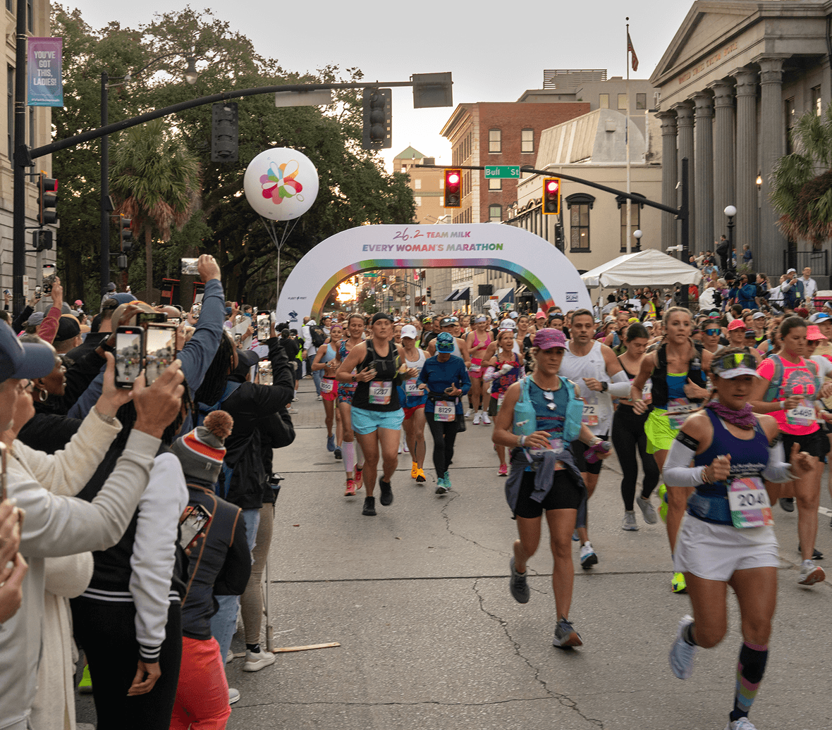 An Every Woman's Marathon runner wearing airpods.