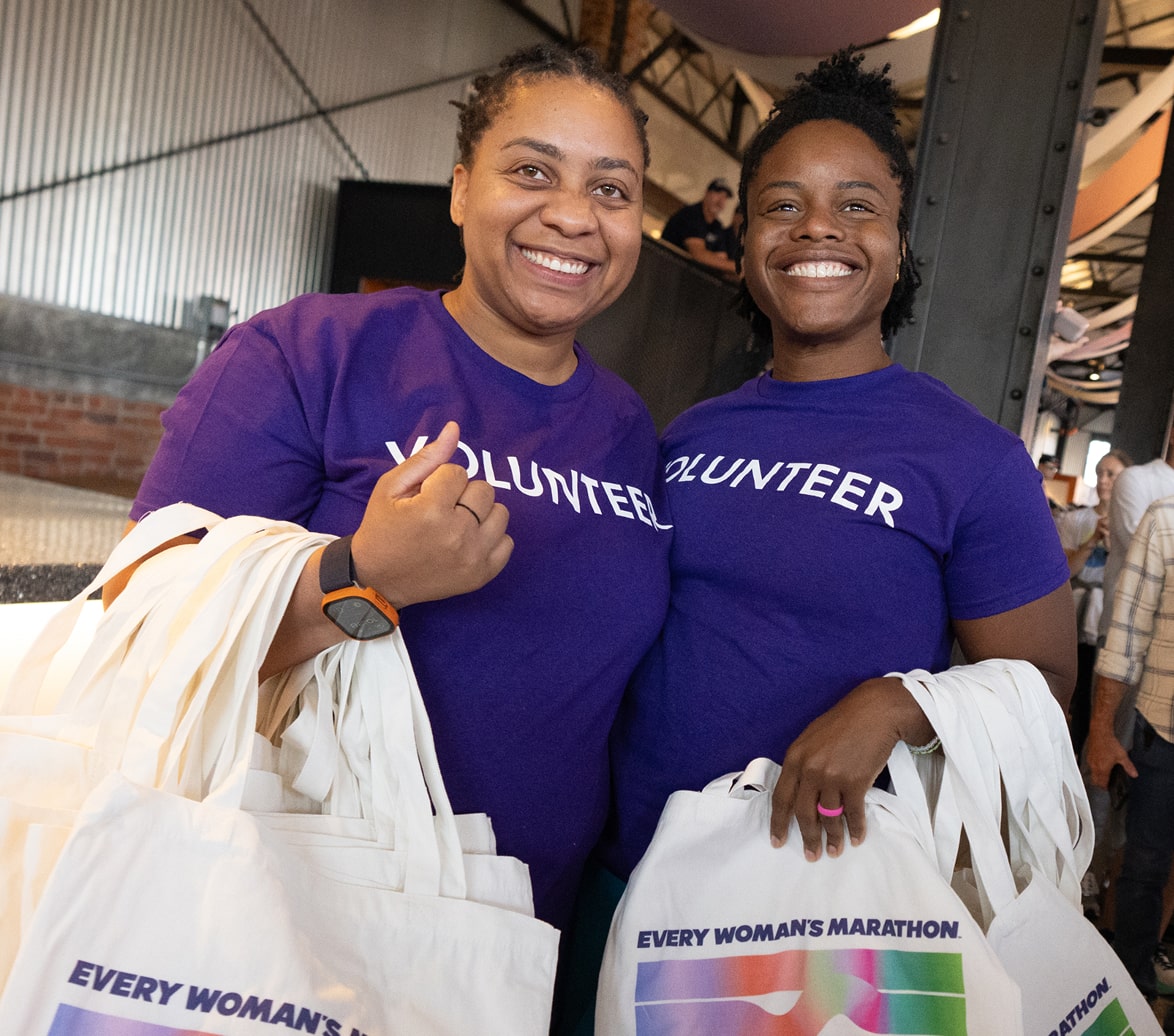 Two women volunteer at the Every Woman’s Marathon Wellness Expo. Two women volunteer at the Every Woman’s Marathon Wellness Expo.