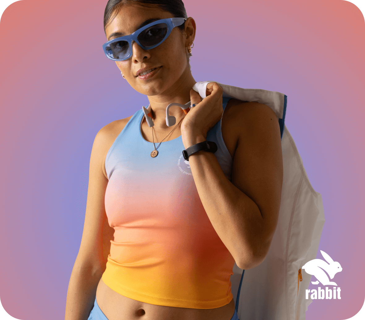 Runner wearing an Every Woman’s Marathon Crusher Pocket Crop and holding a Momentum jacket over her shoulder