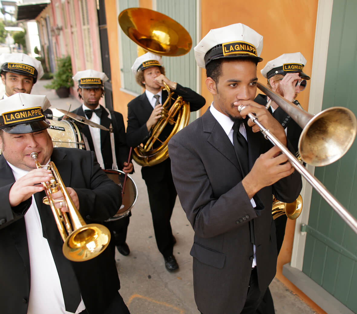 A Jazz band walking down the street.
