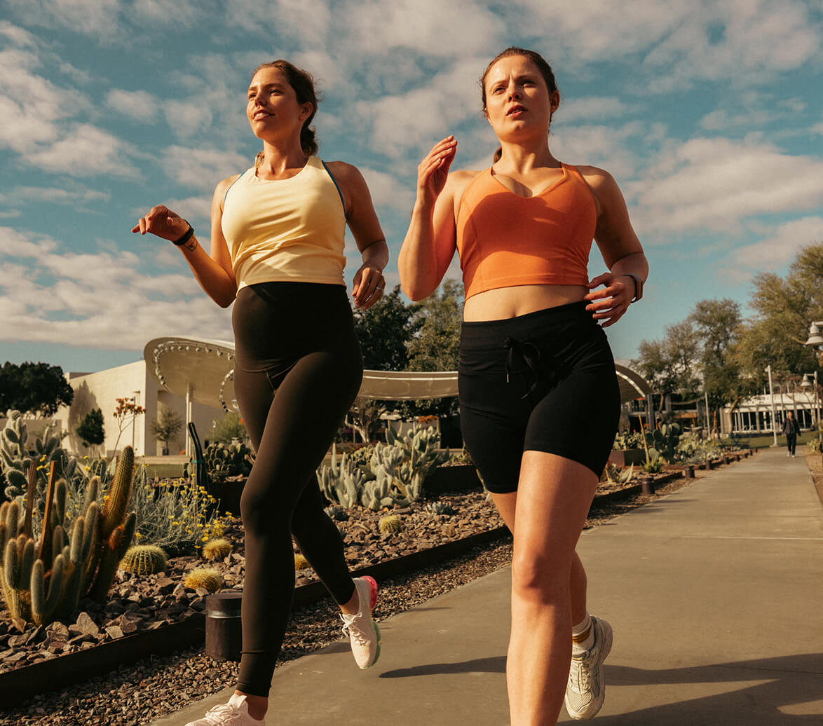 Two women race through a neighborhood during a weekly easy effort run.